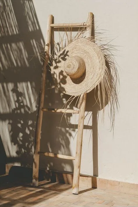 A straw hat resting against a wall
