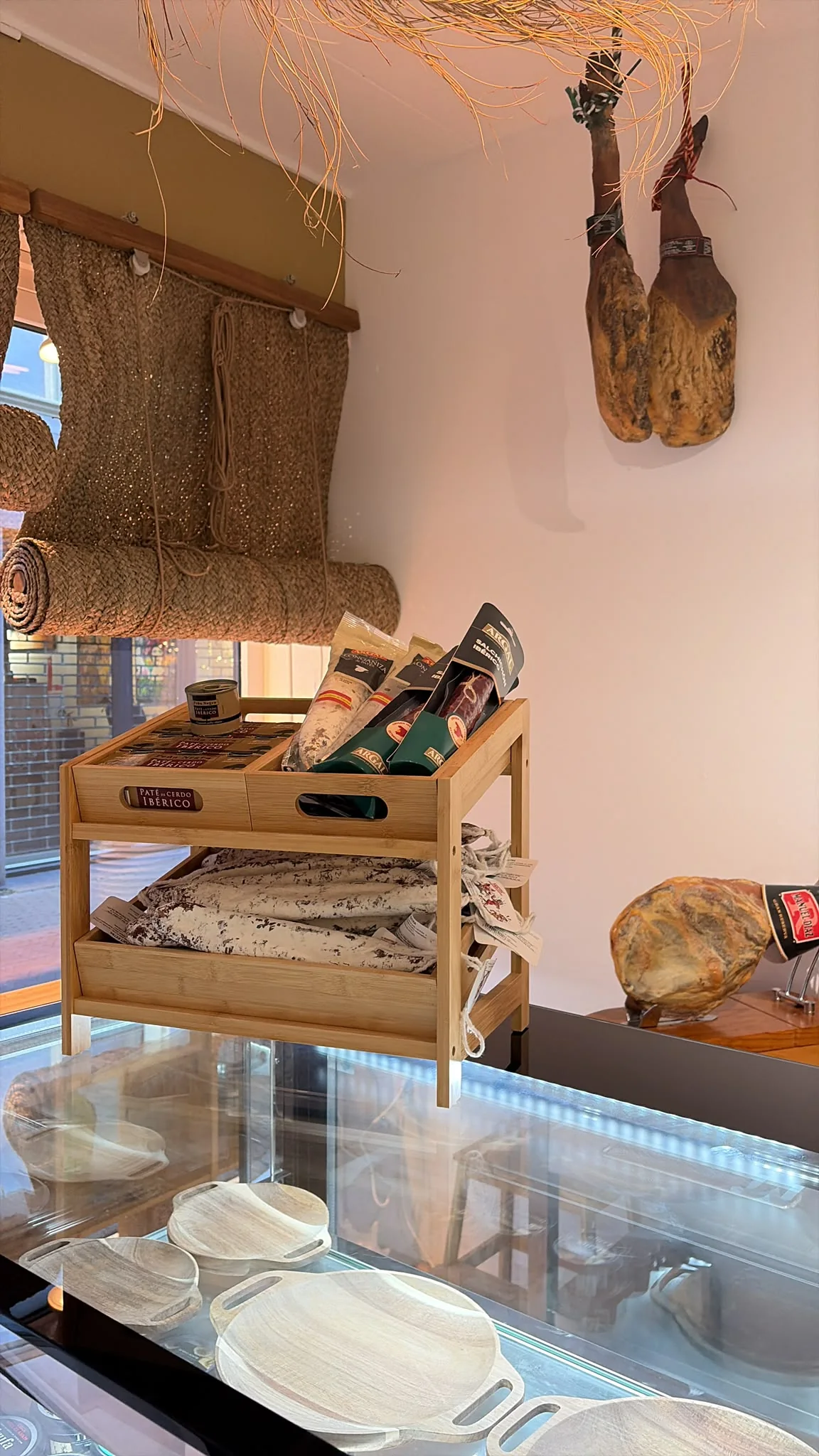 The charcuterie counter at El Colmado, with hanging jamón